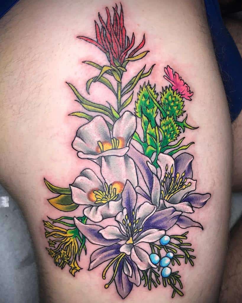 Colorful floral tattoo featuring various flowers on a thigh