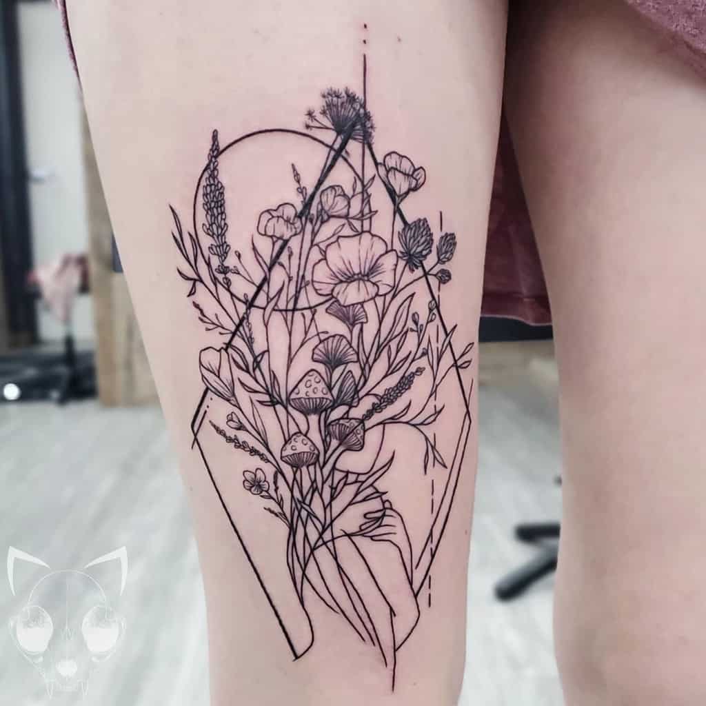 Geometric floral tattoo with mushrooms on the back of an upper leg