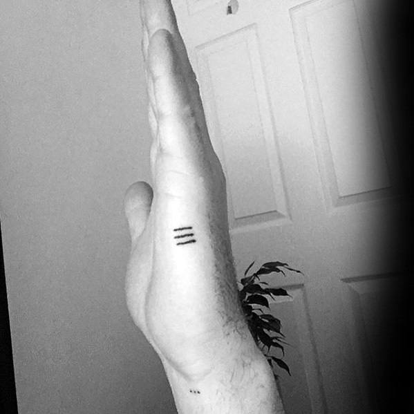 Side hand tattoo for men with three simple horizontal black lines stacked evenly along the edge of the hand.