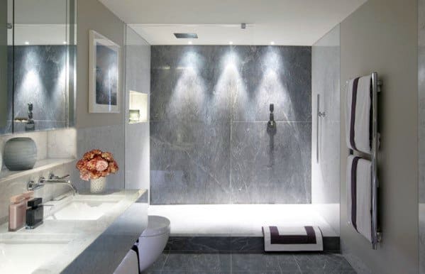 Elegant bathroom with recessed LED ceiling lights, illuminating a sleek marble shower wall for a sophisticated, modern look