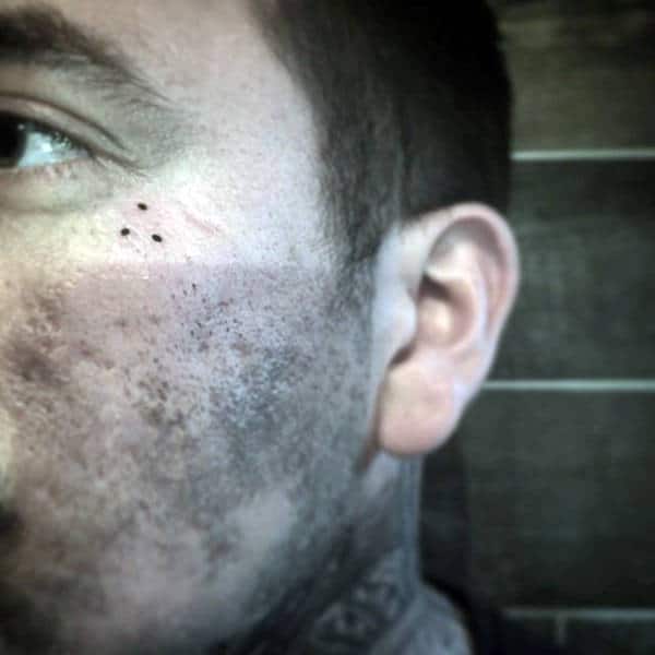 Small 3 dot tattoo near the eye