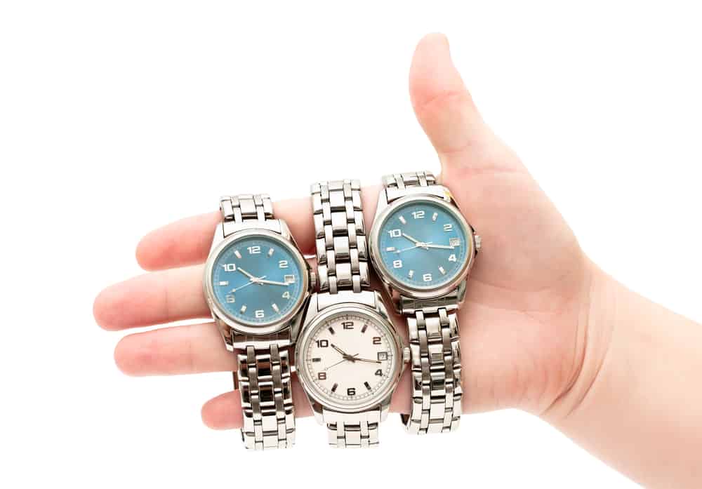 three different wristwatches on womens hand