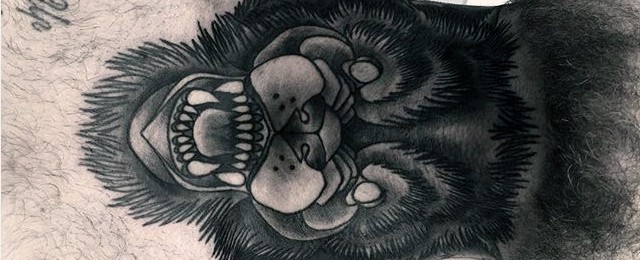 Black and grey throat tattoo of a roaring gorilla with detailed fur shading and fierce expression, creating a bold and powerful look