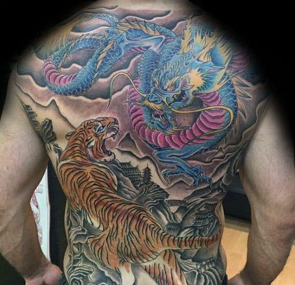 Full-back tattoo featuring a tiger and dragon with vivid colors and intricate detailing