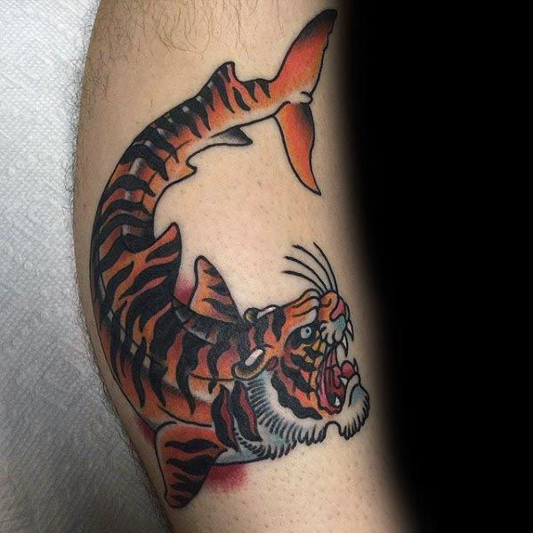 Tiger shark hybrid tattoo with a roaring tiger head and striped shark body, done in bold traditional style with vivid orange and black tones.