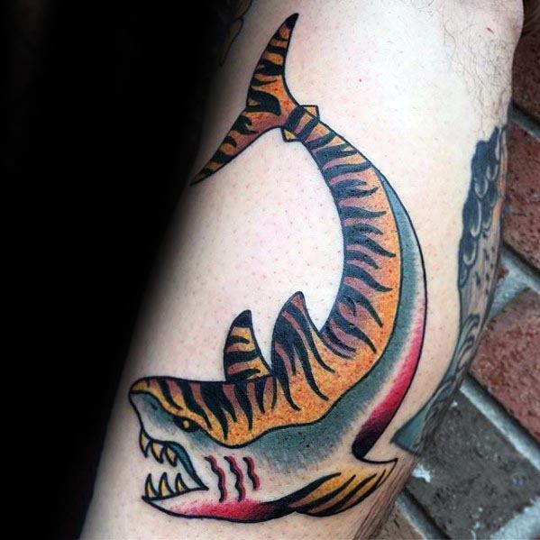 Traditional tiger shark tattoo with bold black stripes, orange and yellow tones, red gill slashes, and a fierce open-mouth pose.