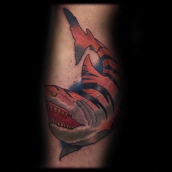 Dark-toned tiger shark tattoo with deep red mouth, sharp teeth, and bold black stripes, creating a fierce and moody underwater design.
