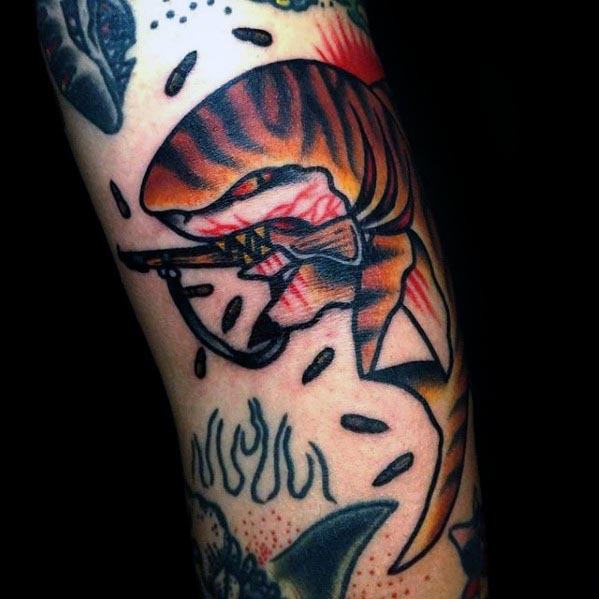 Fierce tiger shark tattoo with bold orange stripes, sharp teeth, and a harpoon through its body, surrounded by black droplets and flames.