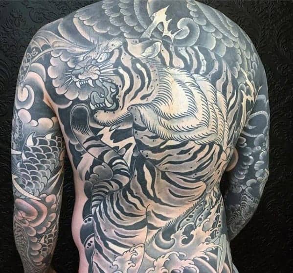 Traditional Japanese full-back tattoo showcasing a fierce tiger surrounded by flowing clouds and intricate shading