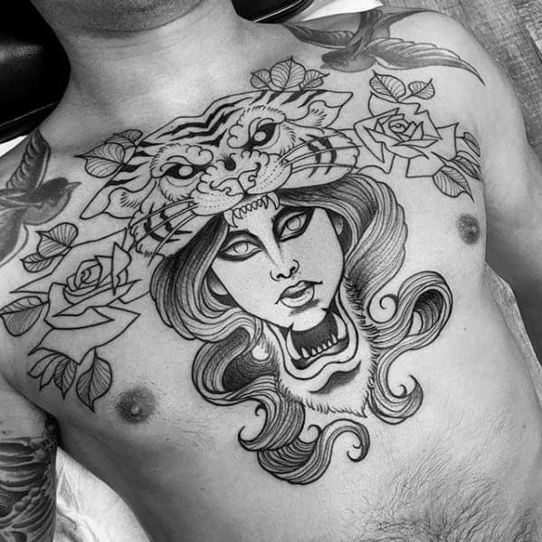 Black and gray chest tattoo of a woman's face with a tiger above, surrounded by roses and leafy vines