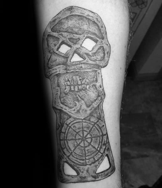 Black and gray tattoo of the iconic *The Goonies* skeleton key, featuring a skull design with intricate details and a treasure map compass.