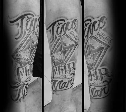 Black and grey tattoo featuring a stylized hourglass, bold script, and the phrase Time Waits for No Man on the forearm.