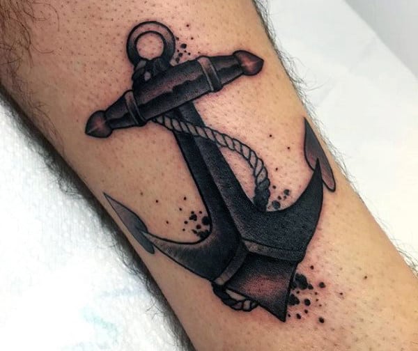 Tattoo of a black anchor with rope on an arm