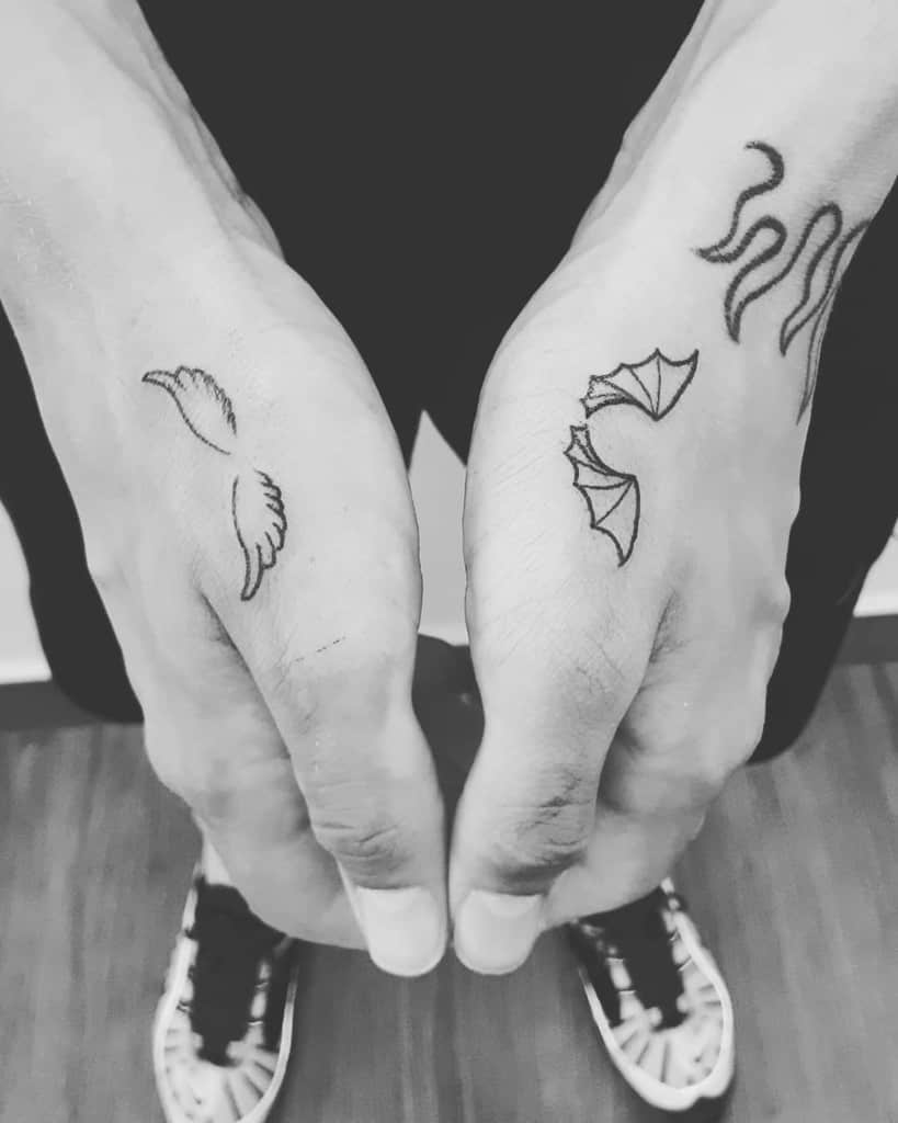 Minimalist angel and demon wing tattoos symbolizing duality and balance between good and evil in a simple line design