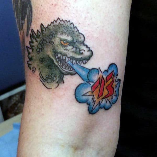 Tiny Godzilla Speaking Japanese Tattoo On Guys Inner Arm