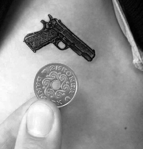 Tiny Male Quarter Sized Pistol Arm Tattoo Ideas