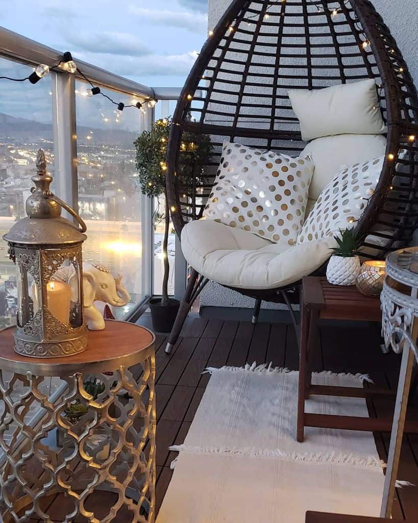 small wood deck balcony with egg chair and fairy lights