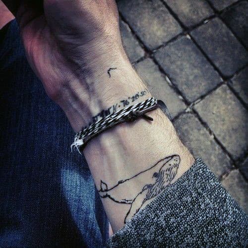 Person with a whale tattoo on wrist