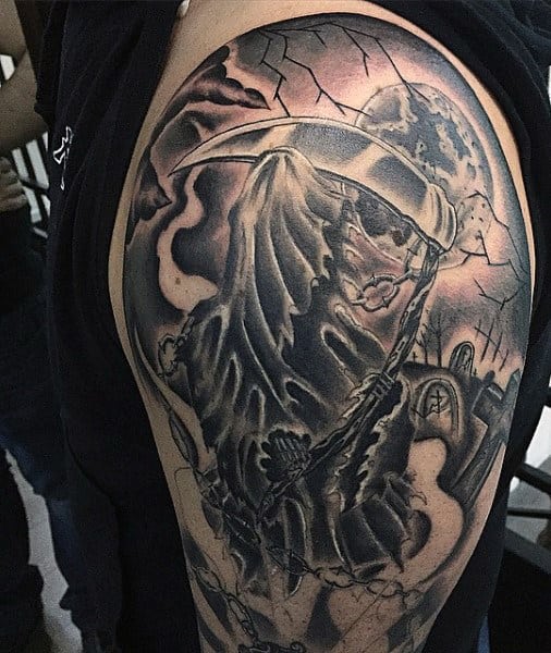 Grim Reaper tattoo on a person's upper arm, featuring a dark, eerie background and cracked effects, set against a haunting graveyard scene