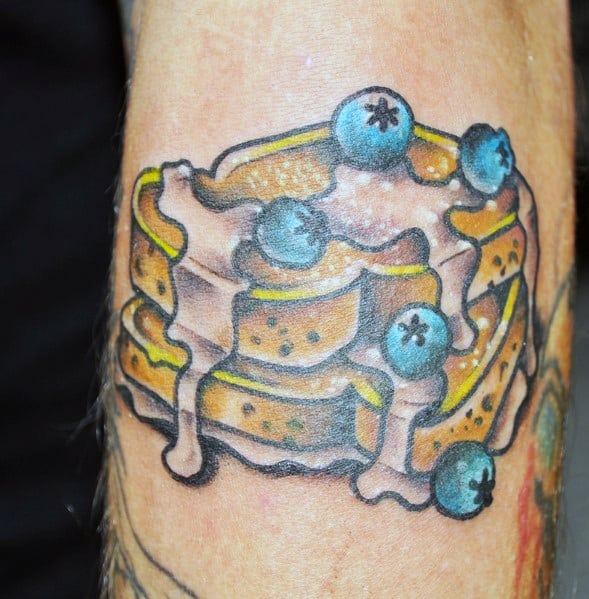 Vibrant French toast tattoo featuring stacked slices with dripping syrup, blueberries, and bold shading for a rich and appetizing design.