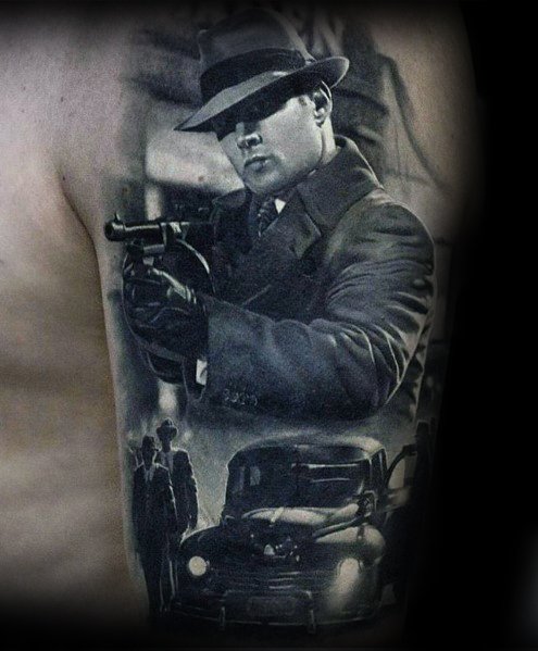 Realistic black and grey gangster tattoo featuring a suited mobster with a Tommy gun, a vintage car, and shadowy figures, creating a cinematic crime scene.