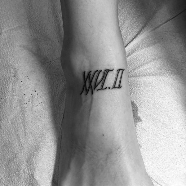 Clean Roman numeral XXVI.II tattoo on the ankle, subtly honoring the accomplishment of completing a 26.2-mile marathon.