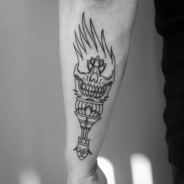Minimalist linework torch tattoo featuring a grinning skull with tall flames and a geometric base design on the forearm.