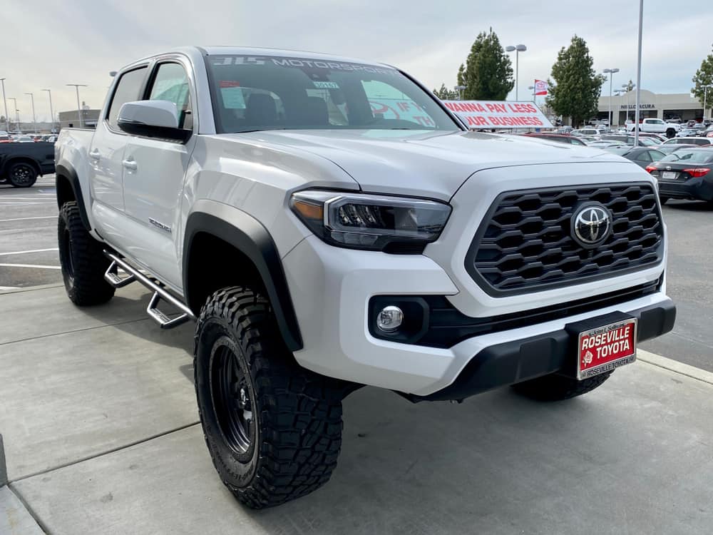 white toyota tacoma pickup truck 2020 year model on a dealership lot