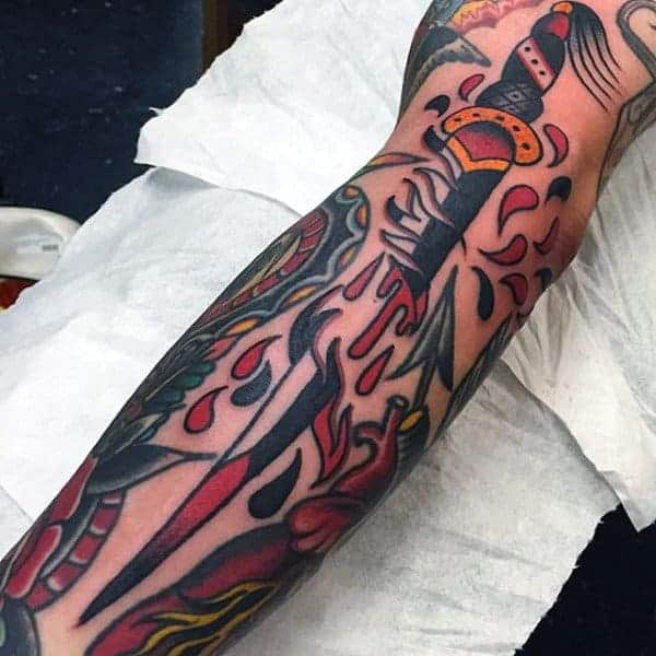 traditional-american-tattoo-of-knife-sliced-in-two-guys-forearms