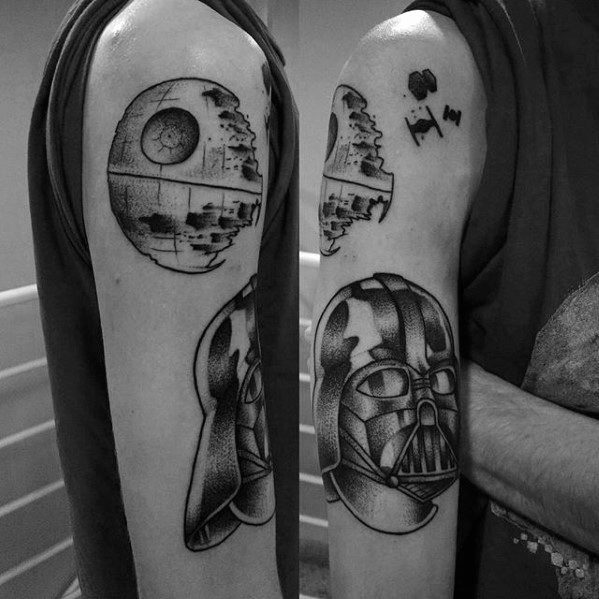 Bold black ink tattoo showcasing the Death Star and Darth Vader's helmet on the upper arm