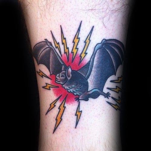 Traditional flying bat tattoo with outstretched wings, surrounded by yellow lightning bolts and a red burst background.