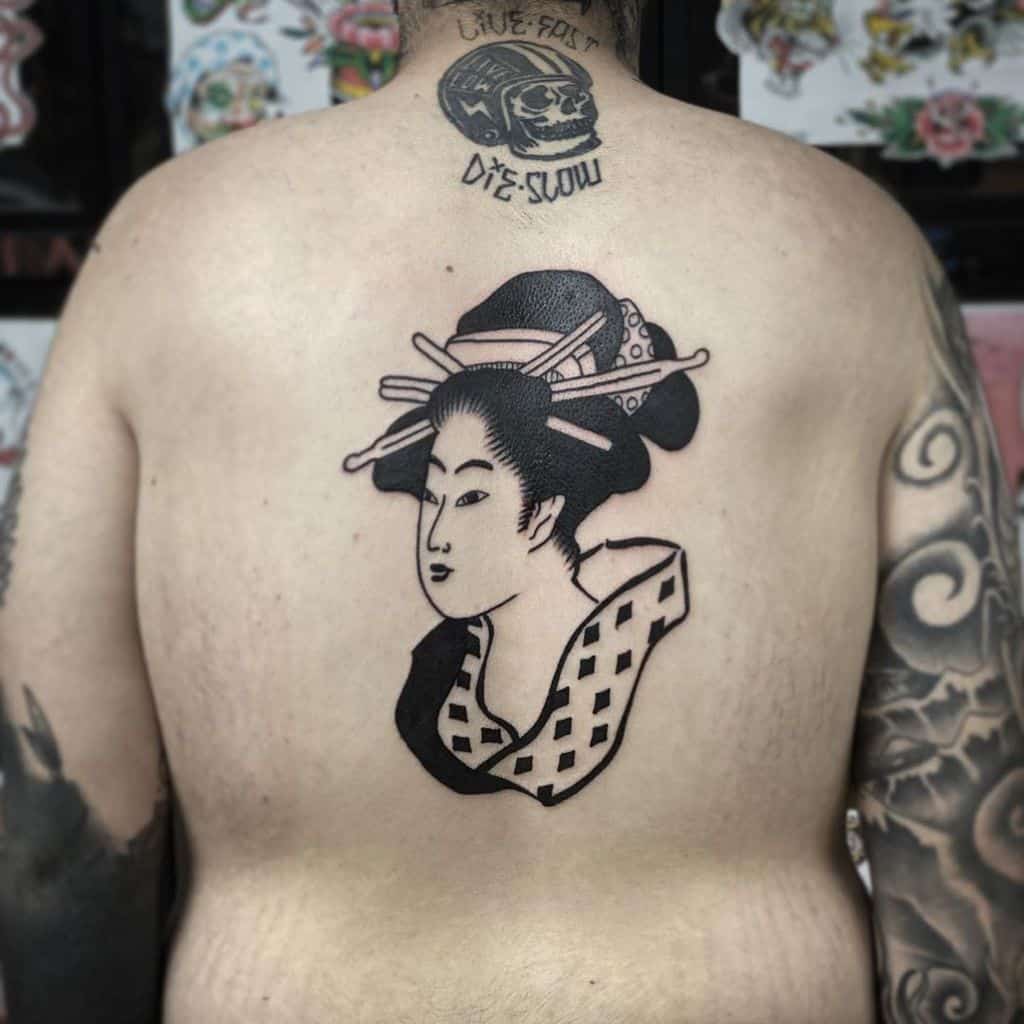 Bold blackwork back tattoo of a Geisha with traditional hair ornaments and a patterned kimono, designed in a minimalist Japanese style.