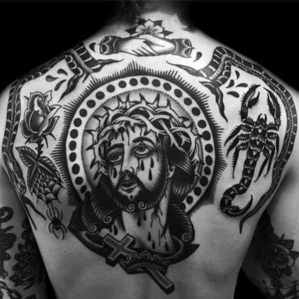 Back tattoo featuring Jesus, hands in prayer, a scorpion, and various other designs