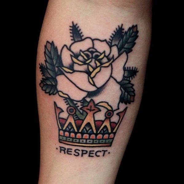 Traditional tattoo featuring a gold crown with the word “RESPECT” below a white rose and bold green leaves.