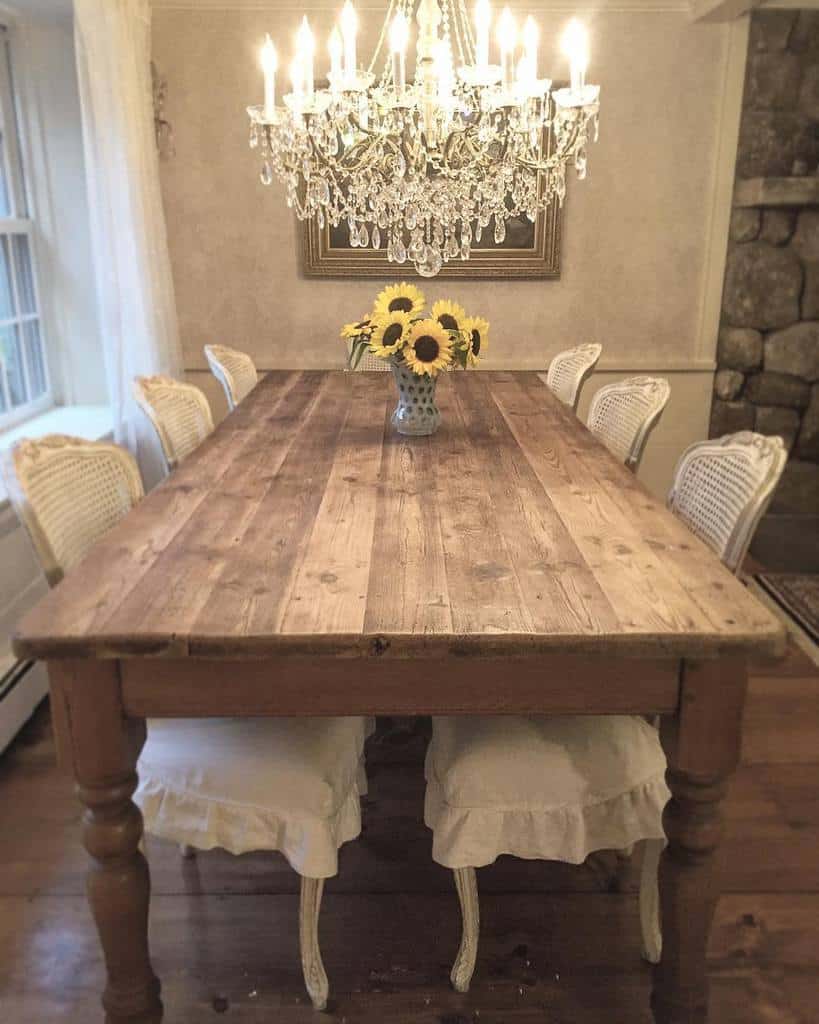 traditional dining room wood table flowers in vase low hanging chandelier
