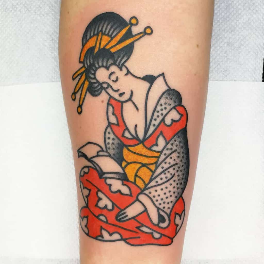 Traditional-style Geisha tattoo on the forearm, featuring bold black outlines, a red and gold kimono, and a peaceful expression while reading.