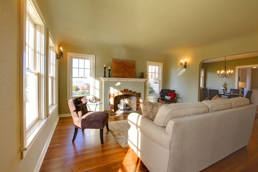 traditional family room cream couches accent chair fireplace chandelier