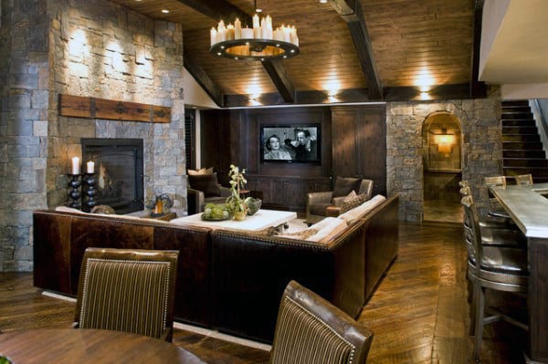 traditional basement stone walls and hardwood flooring chandelier