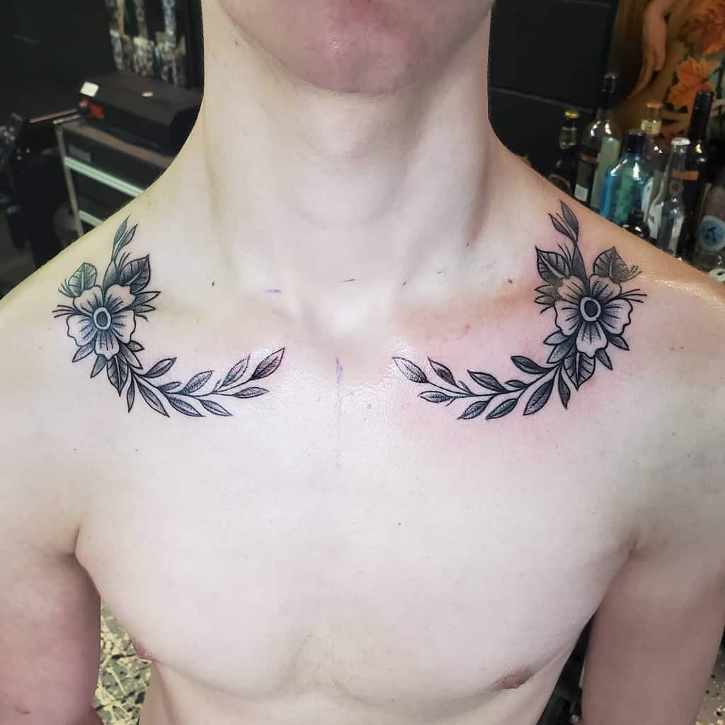 Floral tattoos gracing their collarbones and shoulders, featuring symmetrical flowers and leaves