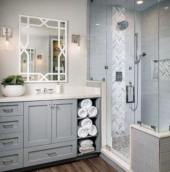 Traditional grey bathroom with a herringbone tile shower and a stylish vanity.