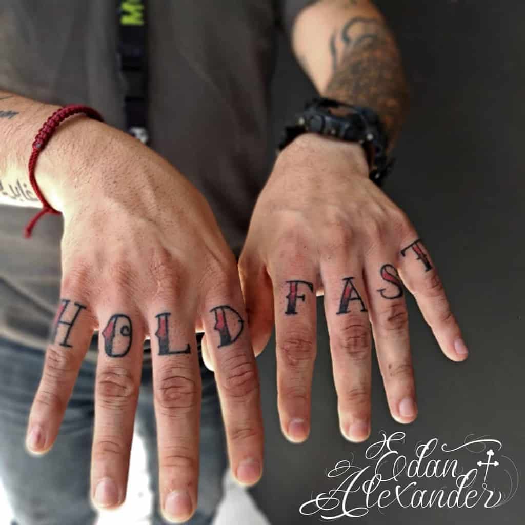 Man with "HOLD FAST" tattooed on fingers
