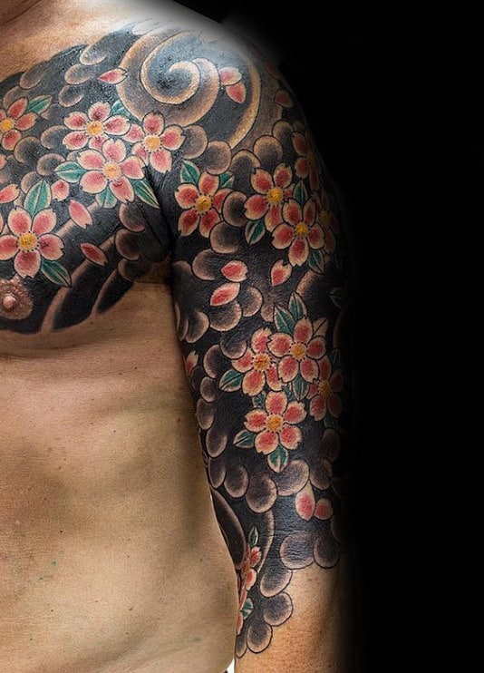 Traditional Japanese half-sleeve tattoo featuring vibrant cherry blossoms over bold black and grey swirling patterns for a striking look