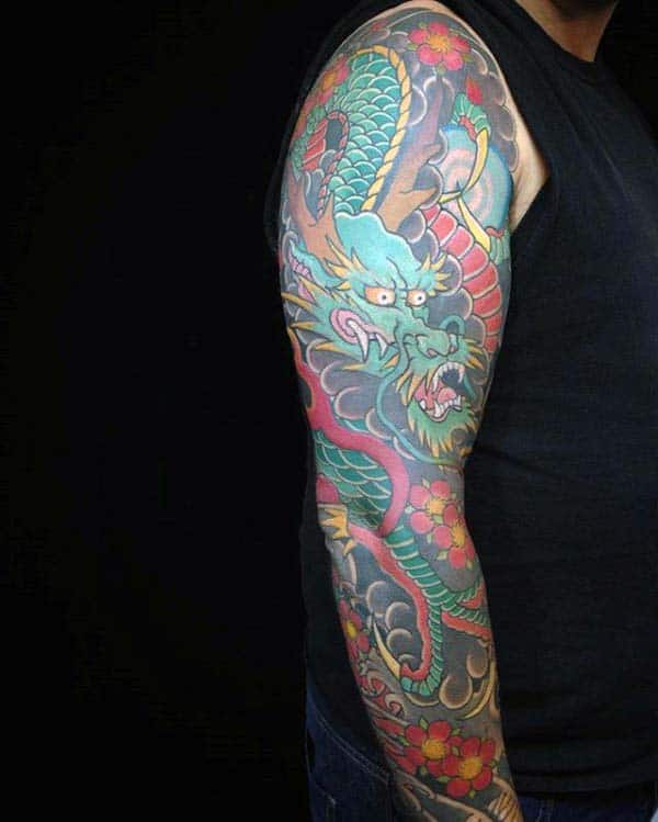 Traditional Japanese full-sleeve tattoo featuring a colorful dragon surrounded by vivid floral designs and bold clouds