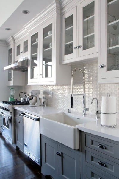 Polished mosaic tiles provide a subtle shine, enhancing the elegance of this traditional kitchen backsplash.