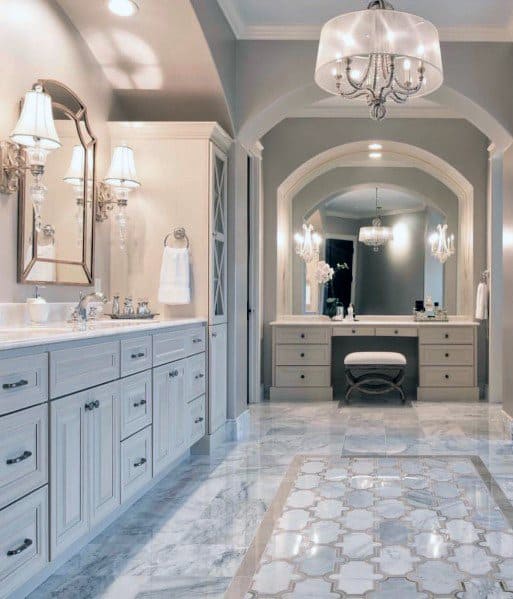 Elegant bathroom with marble floors, double vanity, and silver chandeliers for a luxurious look.