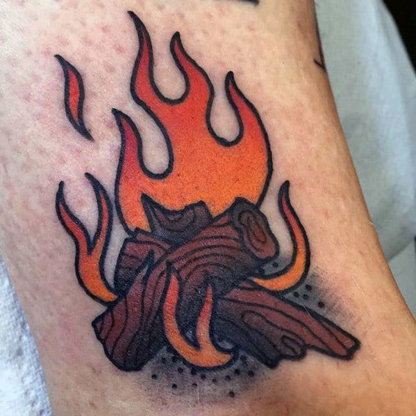 Bold traditional campfire tattoo with glowing orange flames, charred wood logs, and dotwork shading around the base.