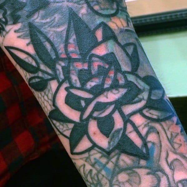Blast over with an intricate black and gray geometric and floral arm tattoo