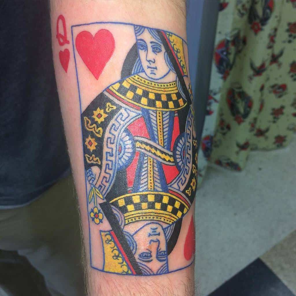 Tattoo of queen of hearts playing card on a person's arm