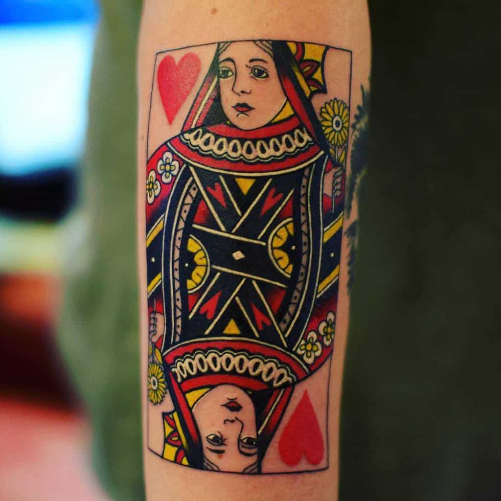 Tattoo of a Queen of Hearts playing card on an arm
