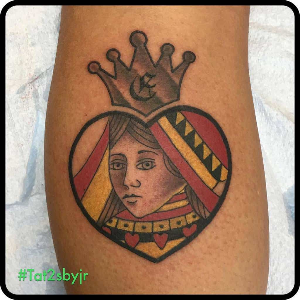 Tattoo of a queen of hearts with a crown inside a heart shape on skin